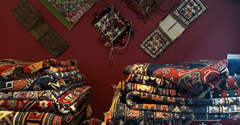 Handwoven Textiles - Stacks of Handwoven Carpets and Bags in a Rug Shop