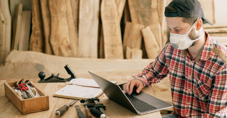 Wood Projects - Man Using a Laptop at a Wood Workshop